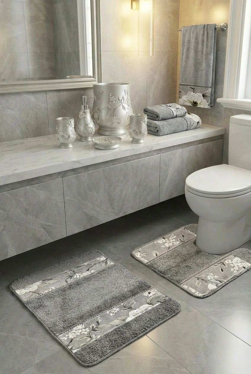 Melrose Yellow bath rug — warm golden plush mat with ivory botanical floral border beside ivory ceramic accessories and yellow towels in bright marble bathroom
