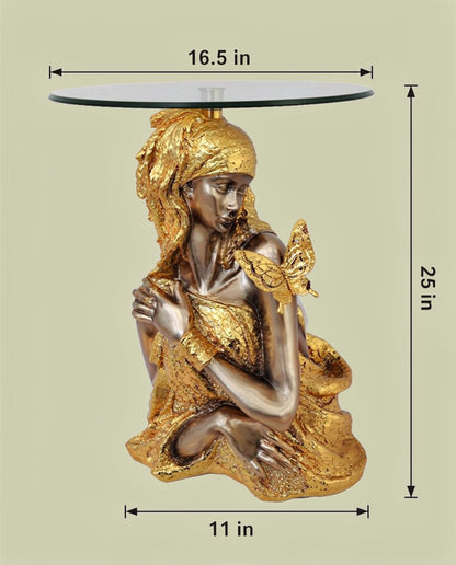 Gold & Silver Butterfly Goddess Sculptural Glass Side Table with dimensions — 25 inch height, 16.5 inch glass top diameter and 11 inch base width on light greenish-beige background, seated dual-tone gold and silver-bronze goddess with flowing golden headdress and gold butterfly on raised hand