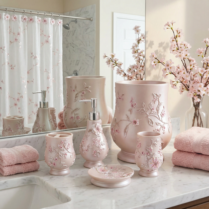 Melrose Grey accessories set lifestyle — 5-piece raised botanical resin vanity set on marble counter in bright white bathroom beside chrome faucet and stacked grey towels