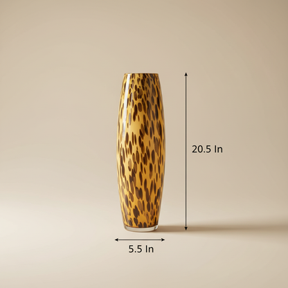Amber Leopard Tall Column Vase with dimensions — 20.5 inch height and 5.5 inch width shown on light beige background, warm amber hand-blown glass elongated column with bold dark brown and black tortoiseshell leopard spot pattern throughout