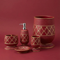 Cassandra Red accessories set — waste basket, toothbrush holder, tumbler, lotion dispenser and soap dish in crimson and gold in bathroom setting