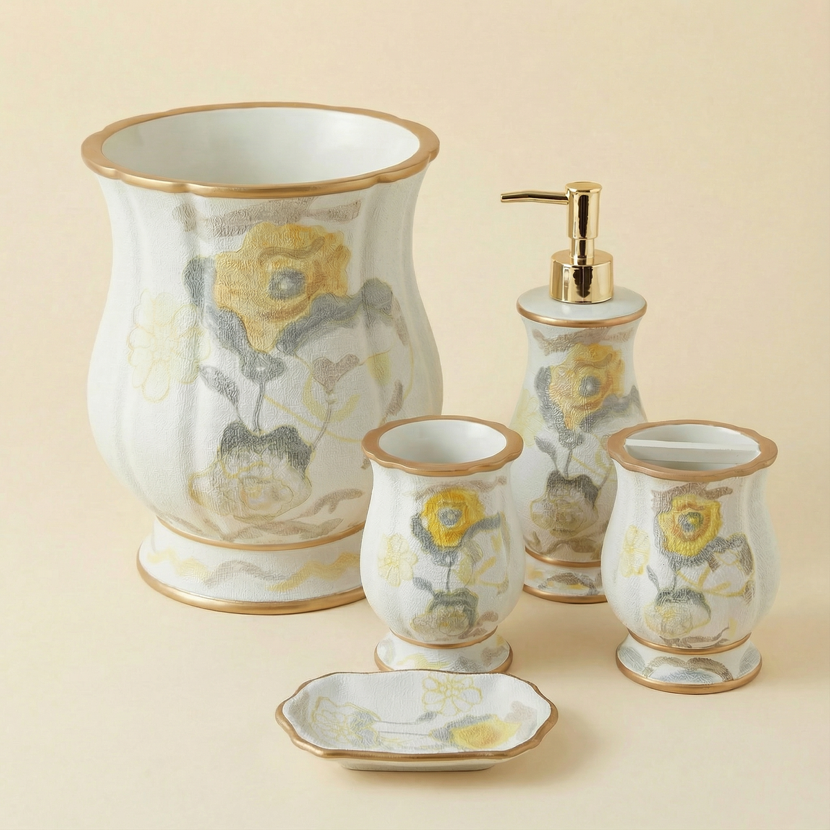 Judy accessories set Blue — blue botanical floral ceramic pieces with gold rim on marble vanity counter including waste basket, dispenser, tumbler and soap dish