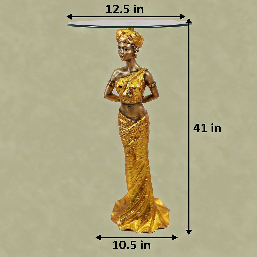 Gold African Queen Sculptural Glass Side Table with dimensions — 41 inch total height, 12.5 inch glass top diameter and 10.5 inch base width on light greenish-beige background, full gold draped goddess figure in turban with round clear glass top