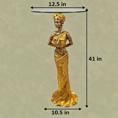 Gold African Queen Sculptural Glass Side Table with dimensions — 41 inch total height, 12.5 inch glass top diameter and 10.5 inch base width on light greenish-beige background, full gold draped goddess figure in turban with round clear glass top