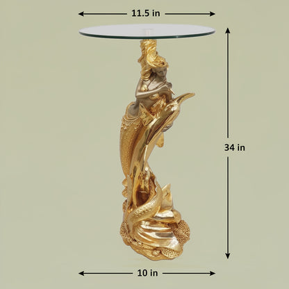 Gold Mermaid Sculptural Glass Side Table with dimensions — 34 inch total height, 11.5 inch glass top diameter and 10 inch base width shown on light greenish-beige background, full gold mermaid and dolphin sculptural pedestal with clear round glass top