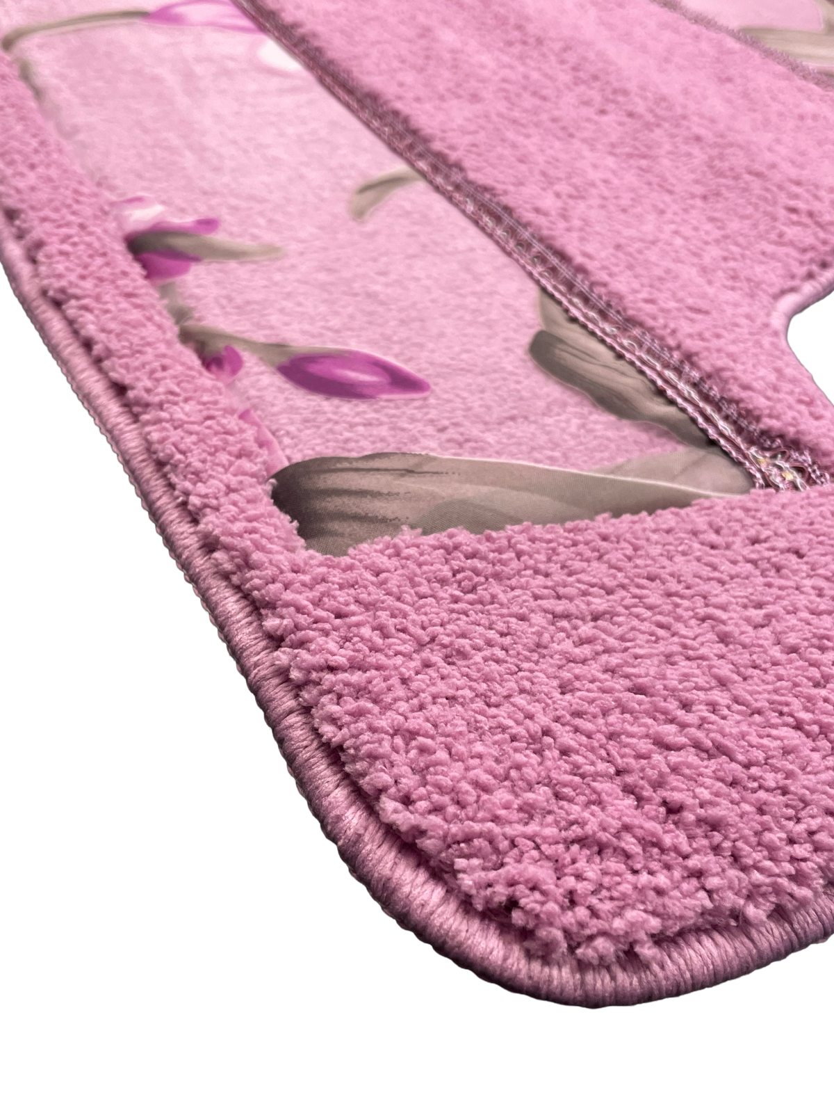 Lily Purple bath rug close-up — rose pink plush pile with lavender orchid blossom print center panel, non-slip backing detail