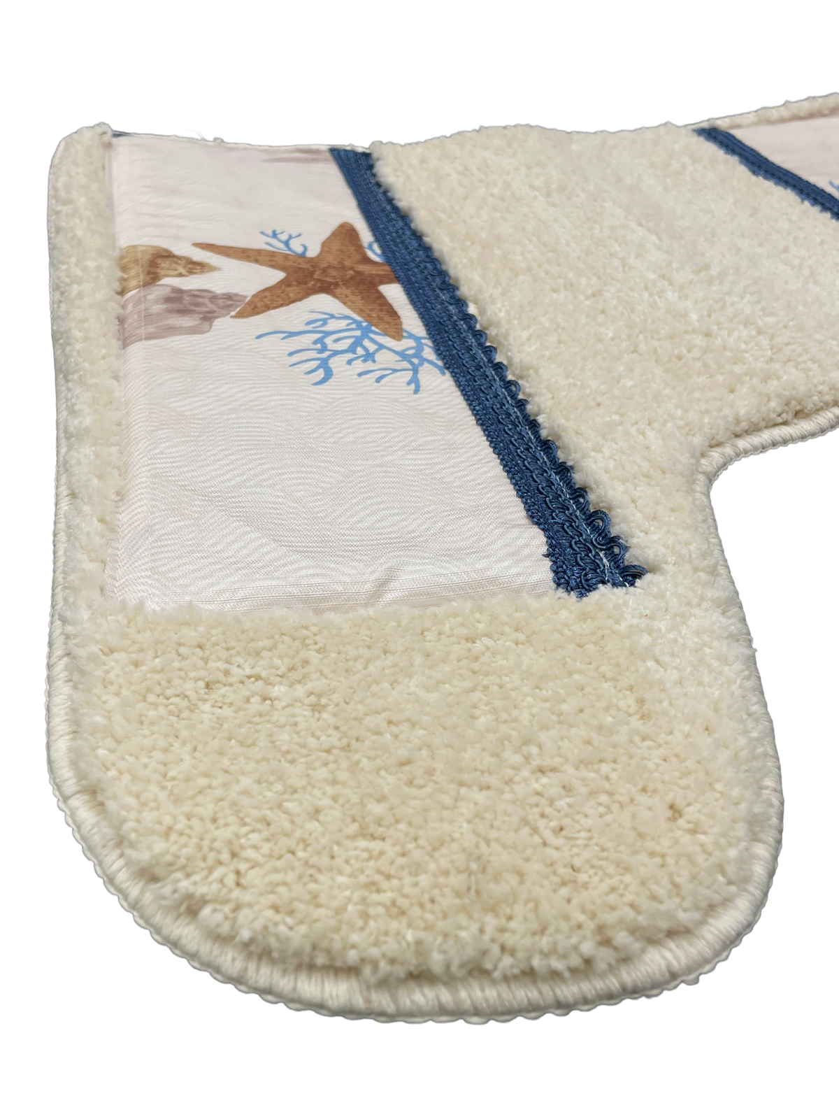 Spa Shell bath rug close-up — plush ivory chenille with starfish coral print inset and navy grosgrain ribbon border detail
