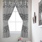 Sinatra Silver window curtain — cool silver-grey fabric with brilliant silver sequin medallion embroidery bands, attached valance and tie-backs in bright bathroom with morning light