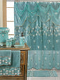 Maya Raspberry shower curtain — rich coral-pink sheer panel with white embroidered daisy garlands and dramatic swag valance with coordinating ceramic accessories and towels