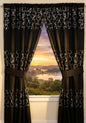 Sinatra Black window curtain — dramatic deep black fabric with dazzling silver sequin medallion ring embroidery bands, valance and tie-backs with scenic sunset view through window